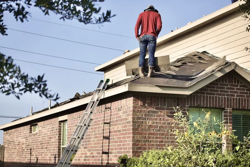 Professional roofer working on a residential roof in Stoutsville